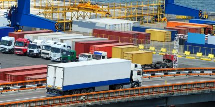 White lorry driving past an industrial unit